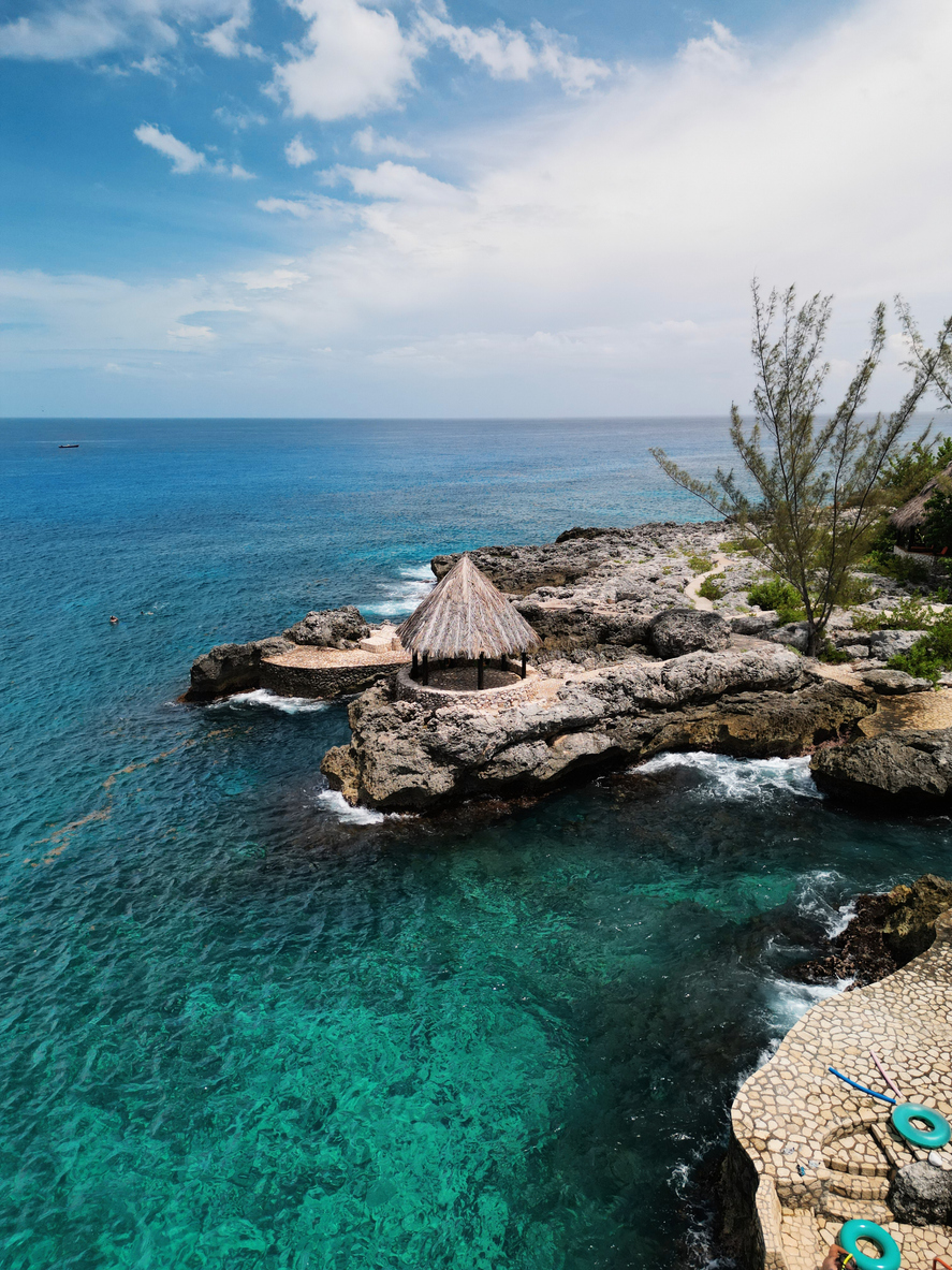 Palm trees and blue water along the Jamaican coast