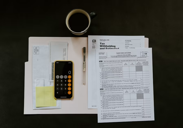 Investment charts with calculator and glasses